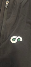 Load image into Gallery viewer, Close-up of a black long shorts with a logo on the thigh area.
