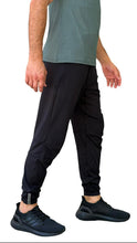 Load image into Gallery viewer, Person wearing black jogger pants and a green shirt on a white background
